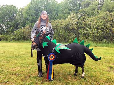 miniature horse dressed as black dragon with green spikes